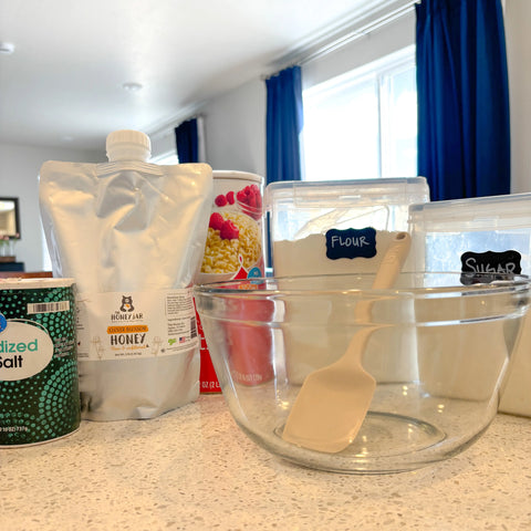 Baking ingredients including honey and bowl on countertop