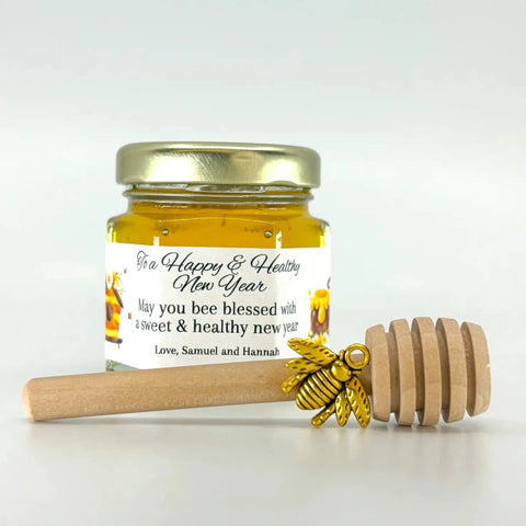 2 oz honey jar favor with gold lid, 3" wooden honey dipper, gold bee charm, and personalized honey-themed design on label with To a Happy & Healthy New Year as the title.