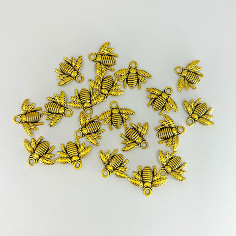 Gold colored bee charms are shown scattered across the image.
